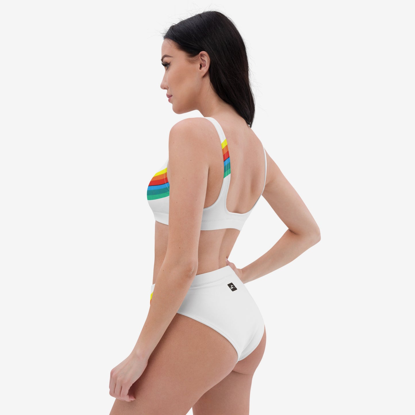 Young fit girl wearing white retro Soviet Olympics bikini set with Moscow 1980 Olympic Games logo - left side