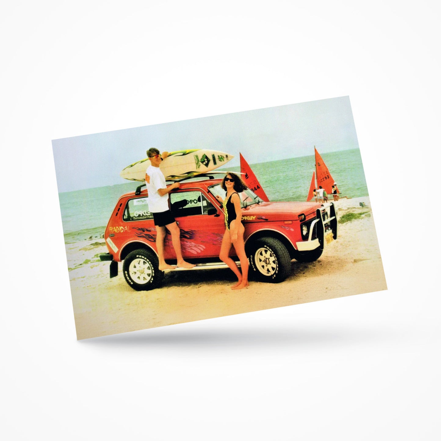 Vintage-style postcard featuring a classic Lada Niva 4x4 parked on a beach