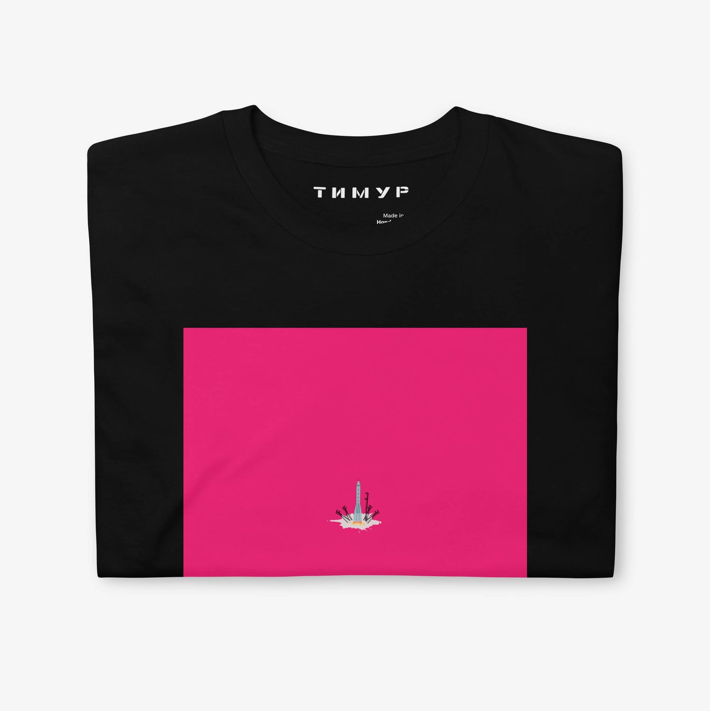 Timur Novikov Старт (Start) T-shirt featuring a Soviet space rocket launching from a cosmodrome. Bold avant-garde artwork with a pink background.