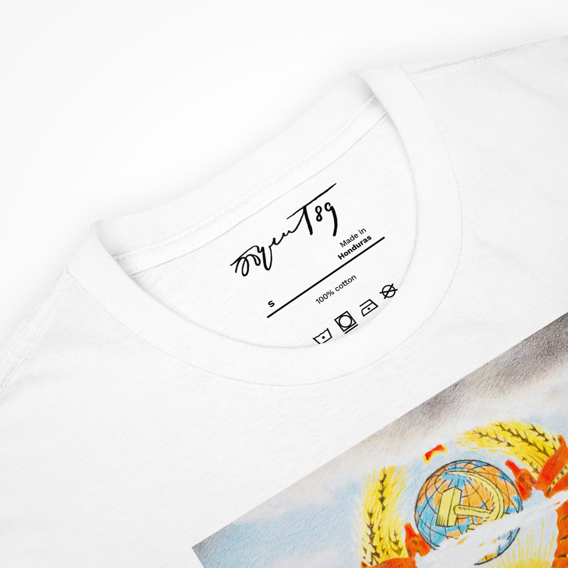 Neck label of a white T-shirt featuring Eric Bulatov's signature for authenticity.