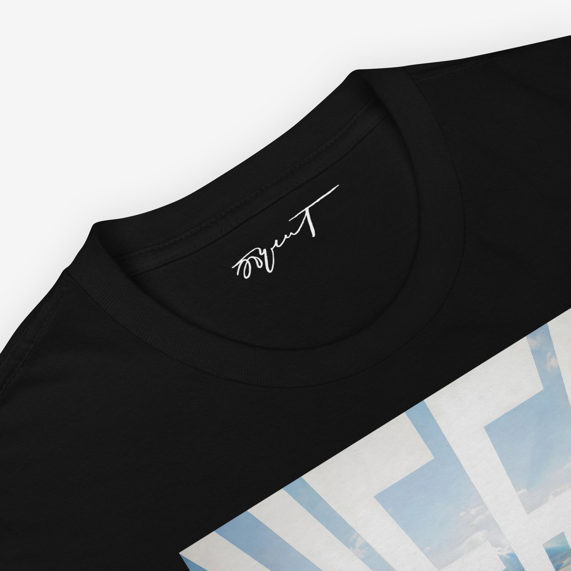 Close-up of Erik Bulatov's Sky and Sea artwork on a black T-shirt, emphasizing the horizon and sky details