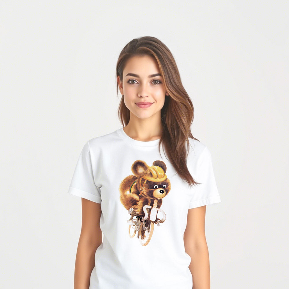 Cute girl wearing white unisex T-shirt with Misha the Bear cycling, rare Moscow 1980 Olympic mascot illustration.