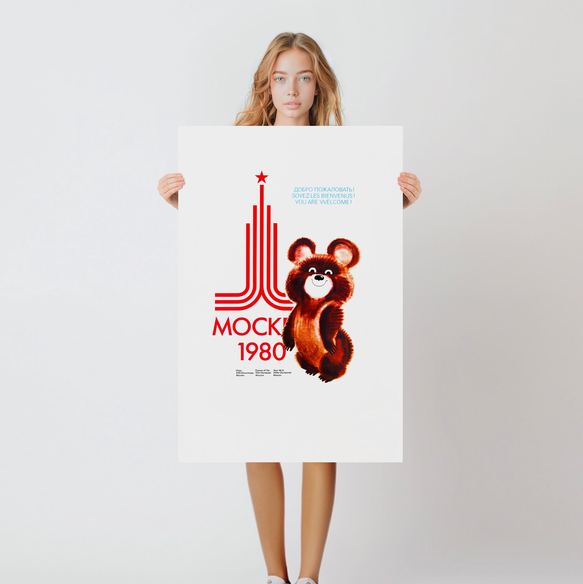 Cute girl holding a large Moscow 1980 Soviet Olympic games poster with bear Misha