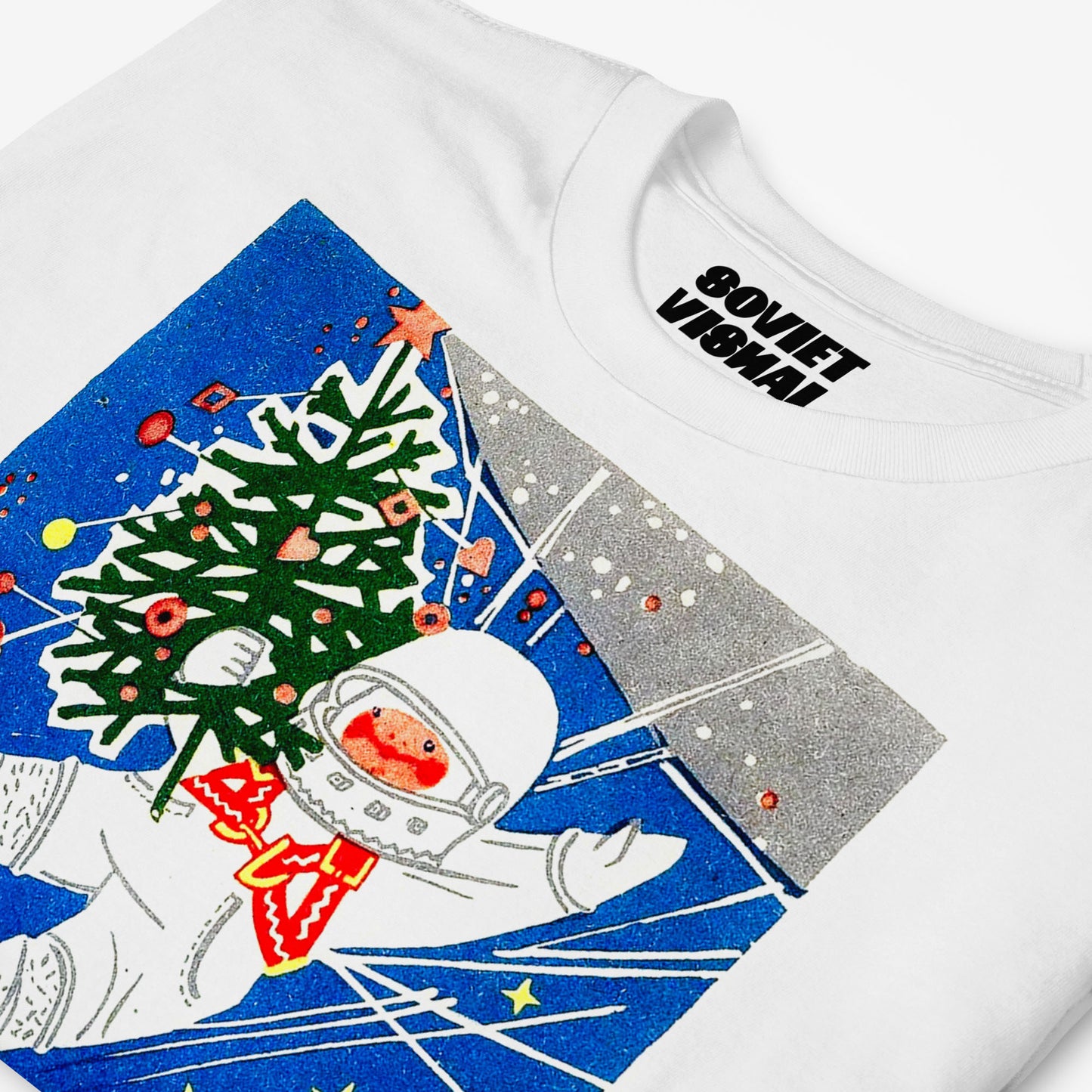 white unisex t-shirt with a young cosmonaut kid in space holding a christmas tree - closeup photo