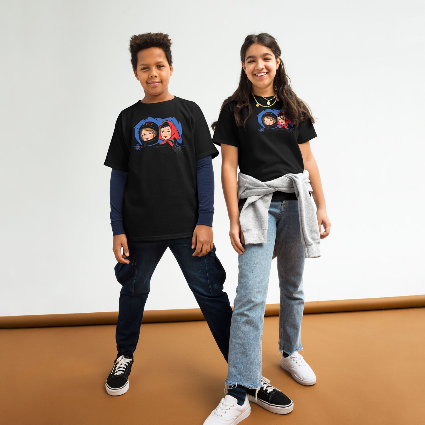 Youth T-shirt featuring a vintage Soviet illustration of a cosmonaut girl and a Russian girl in a traditional headscarf, inspired by USSR space exploration.
