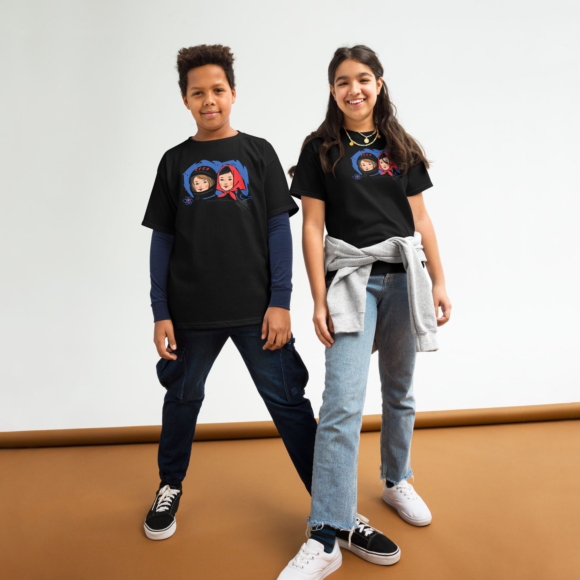 Youth T-shirt featuring a vintage Soviet illustration of a cosmonaut girl and a Russian girl in a traditional headscarf, inspired by USSR space exploration.