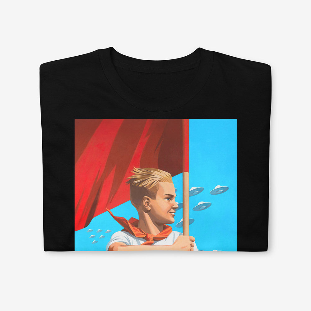 T-shirt with artwork of beautiful blonde Soviet pioneer boy holding red flag with UFO flying in blue sky behind him, space-age patriotic design