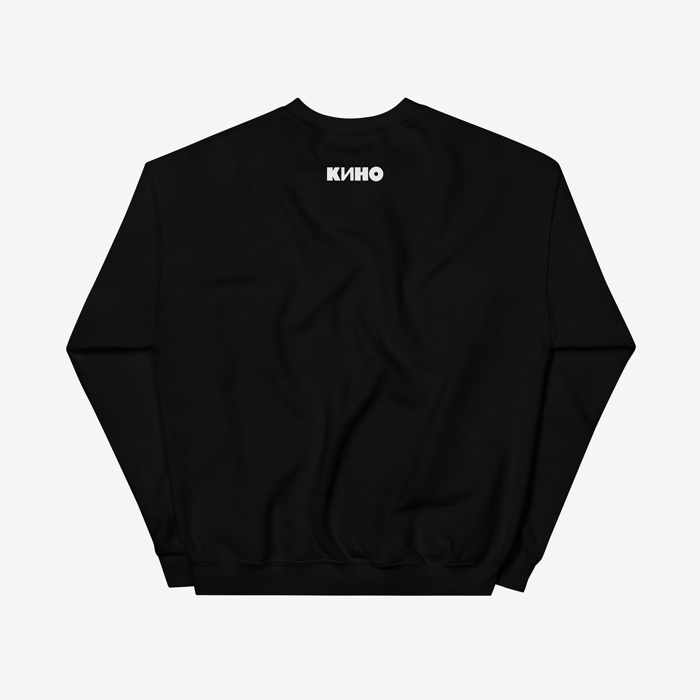 Rare archival photo of Viktor Tsoi in a yellow T-shirt against a white brick wall with a little KINO logo underneath, printed on the front of a heavyweight black unisex sweatshirt with a KINO logo on the back neck side, from GruppaKino.com. Back side.